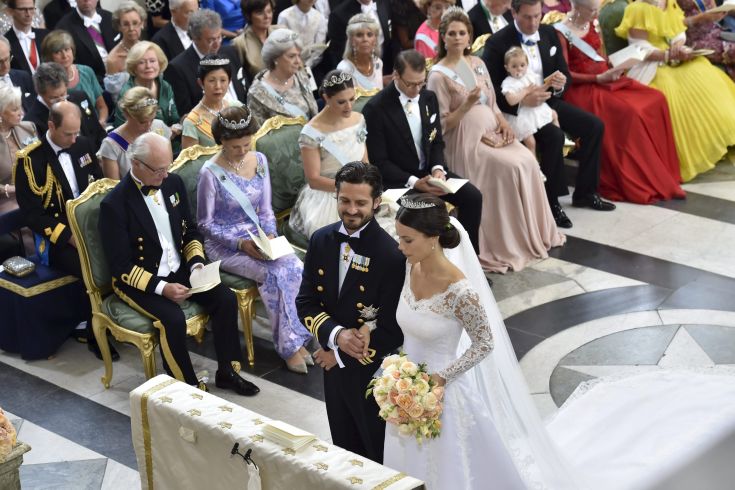 Swedish Prince Carl Philip and Sofia Hellqvist are pictured during their wedding in the Royal Chapel in Stockholm, Sweden, June 13, 2015. In the background are King Carl Gustaf, Queen Silvia, Coriwn Princess Victoria, Prince Daniel and Princess Madeleine. REUTERS/Jonas Ekstromer/TT News Agency  ATTENTION EDITORS - THIS IMAGE WAS PROVIDED BY A THIRD PARTY. THIS PICTURE IS DISTRIBUTED EXACTLY AS RECEIVED BY REUTERS, AS A SERVICE TO CLIENTS. SWEDEN OUT. NO COMMERCIAL OR EDITORIAL SALES IN SWEDEN.      TPX IMAGES OF THE DAY