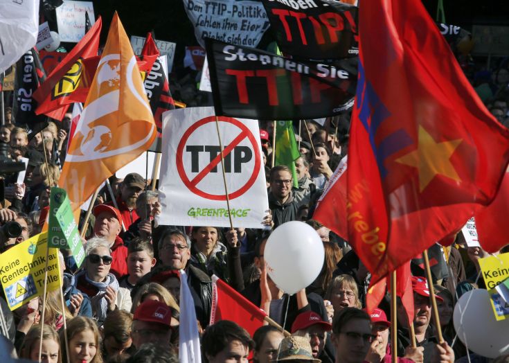 Consumer rights activists take part in a march to protest against the Transatlantic Trade and Investment Partnership (TTIP), mass husbandry and genetic engineering, in Berlin, Germany, October 10, 2015. The European Union is pursuing a trade accord with the United States, called the Transatlantic Trade and Investment Partnership (TTIP), that would encompass a third of world trade and nearly half of global GDP.         REUTERS/Fabrizio Bensch