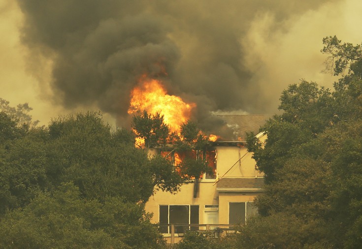 Fire consumes a hillside house on Monday, Oct. 9, 2017, in Santa Rosa, Calif. Wildfires whipped by powerful winds swept through Northern California early Monday, sending residents on a headlong flight to safety through smoke and flames as homes burned. (AP Photo/Ben Margot)