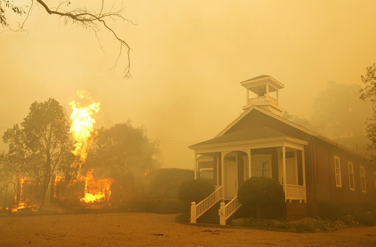 Flames from a propane tank rise as smoke from a wildfire blankets the area on Monday, Oct. 9, 2017, in Napa, Calif. (AP Photo/Rich Pedroncelli)