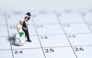 Αγαλματάκι νύφης και γαμπρού πάνω σε ημερολόγιο