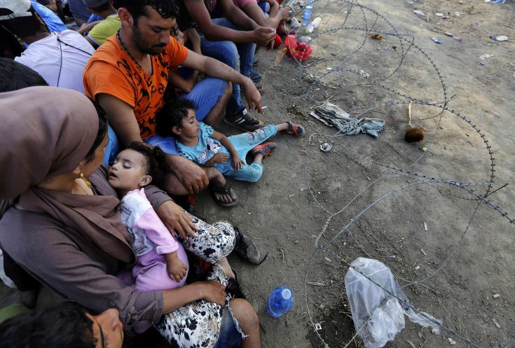 Syrian refugees sit in front of a barbed-wire at the Greek-Macedonian border, near the village of Idomeni, August 21, 2015. Macedonian police fired tear gas and stun grenades to drive migrants and refugees back from its southern border from Greece on Friday but crowds continued to build up at a new bottleneck in an increasingly desperate flight to western Europe. At least 10 people were hurt in the brief flare-up, a day after the impoverished Balkan country declared a state of emergency on its border to halt a daily influx of up to 2,000 Syrians, Afghans, Iraqis and others heading north. REUTERS/Yannis Behrakis Syrian refugees sit in front of a barbed-wire at the Greek-Macedonian border, near the village of Idomeni, August 21, 2015. Macedonian police fired tear gas and stun grenades to drive migrants and refugees back from its southern border from Greece on Friday but crowds continued to build up at a new bottleneck in an increasingly desperate flight to western Europe. At least 10 people were hurt in the brief flare-up, a day after the impoverished Balkan country declared a state of emergency on its border to halt a daily influx of up to 2,000 Syrians, Afghans, Iraqis and others heading north. REUTERS/Yannis Behrakis