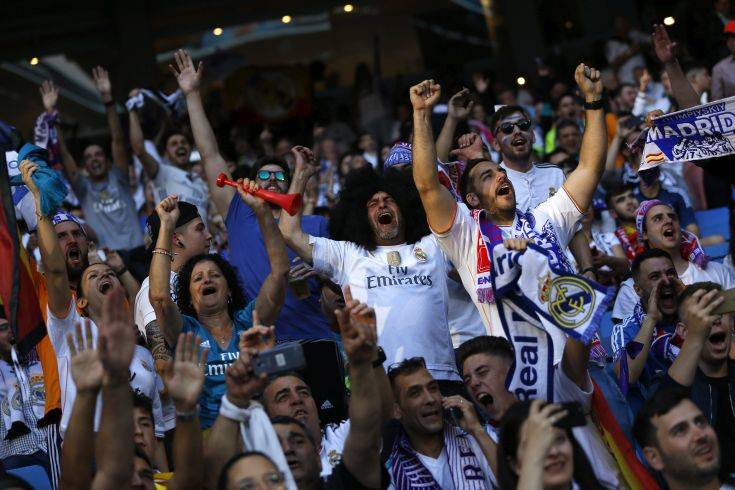 Real Madrid supporters watch on big screens placed in the team's Santiago Bernabeu stadium, as the team play in the Champions League final match between Real Madrid and Liverpool being played in Kiev, Ukraine, in Madrid, Saturday, May 26, 2018. (AP Photo/Francisco Seco) Real Madrid supporters watch on big screens placed in the team's Santiago Bernabeu stadium, as the team play in the Champions League final match between Real Madrid and Liverpool being played in Kiev, Ukraine, in Madrid, Saturday, May 26, 2018. (AP Photo/Francisco Seco)