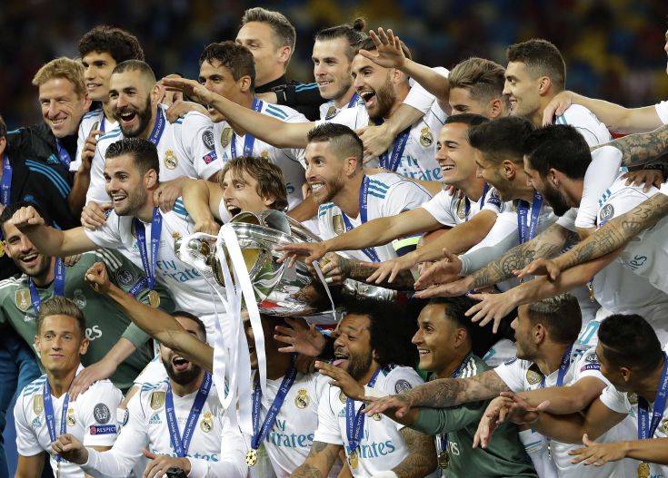 Real Madrid players celebrate with the trophy after winning the Champions League Final soccer match between Real Madrid and Liverpool at the Olimpiyskiy Stadium in Kiev, Ukraine, Saturday, May 26, 2018. (AP Photo/Sergei Grits) Real Madrid players celebrate with the trophy after winning the Champions League Final soccer match between Real Madrid and Liverpool at the Olimpiyskiy Stadium in Kiev, Ukraine, Saturday, May 26, 2018. (AP Photo/Sergei Grits)