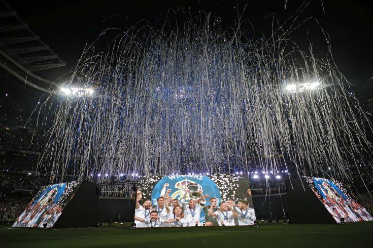 Real Madrid supporters watch on big screens placed at the team's Santiago Bernabeu stadium in Madrid, Spain, for the celebration of their team winning the Champions League final match against Liverpool played in Kiev, Ukraine, Saturday, May 26, 2018. Real Madrid won 3-1. (AP Photo/Francisco Seco) Real Madrid supporters watch on big screens placed at the team's Santiago Bernabeu stadium in Madrid, Spain, for the celebration of their team winning the Champions League final match against Liverpool played in Kiev, Ukraine, Saturday, May 26, 2018. Real Madrid won 3-1. (AP Photo/Francisco Seco)