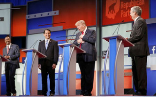 Fellow Republican 2016 U.S. presidential candidates Dr. Ben Carson (L), Wisconsin Governor Scott Walker (2nd L) and former Florida Governor Jeb Bush (R) laugh as fellow candidate and businessman Donald Trump (2nd R) reacts near the end of the debate after realizing that a slew of criticisms spoken by fellow candidate and former Arkansas Governor Mike Huckabee (not pictured) were not aimed at him but at Democratic presidential candidate Hillary Clinton, at the first official Republican presidential candidates debate of the 2016 U.S. presidential campaign in Cleveland, Ohio, August 6, 2015. REUTERS/Brian Snyder