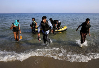 Afghan migrants arrive on the Greek island of Kos after paddling across a part of the Aegean Sea between Turkey and Greece on, August 8, 2015. The U.N refugee agency, UNHCR, estimates that Greece has received more than 107,000 refugees and migrants this year, more than double its 43,500 intake of 2014. REUTERS/ Yannis Behrakis