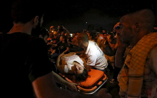 A wounded woman is moved on a stretcher by medics during a protest against corruption and rubbish collection problems near the government palace in Beirut