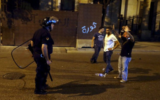 A protestor gestures to a Lebanese Security member during a protest against corruption and rubbish collection problems near the government palace in Beirut