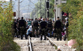 Macedonian special policemen guard the border as more than a thousand immigrants wait at the border line of Macedonia and Greece to enter Macedonia near the Gevgelija railway station August 21, 2015. Macedonian police drove back crowds of migrants and refugees trying to enter from Greece on Friday after a night spent stranded in no-man's land by an emergency decree effectively sealing the Macedonian frontier. REUTERS/Ognen Teofilovski