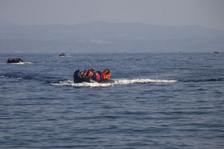 Refugees and migrants are seen onboard eight dinghies as they cross a part of the Aegean Sea from the Turkish coast to reach the Greek island of Lesbos, October 4, 2015. Refugee and migrant arrivals to Greece this year will soon reach 400,000, according to the UN Refugee Agency (UNHCR). REUTERS/Dimitris Michalakis