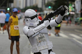 A runner dressed as a Star Wars storm trooper poses for a photo prior to the start of the Sao Silvestre race in Sao Paulo, Brazil, early Sunday, Dec. 31, 2017. The 15-kilometer race is held annually on New Year's Eve. (AP Photo/Nelson Antoine)