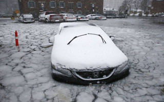 A car sits in floodwaters from Boston Harbor on Long Wharf in Boston, Thursday, Jan. 4, 2018. A massive winter storm swept from the Carolinas to Maine on Thursday, dumping snow along the coast and bringing strong winds that will usher in possible record-breaking cold. (AP Photo/Michael Dwyer)