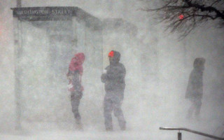 People walk in blowing snow in Boston, Thursday, Jan. 4, 2018. A massive winter storm swept from the Carolinas to Maine on Thursday, dumping snow along the coast and bringing strong winds that will usher in possible record-breaking cold. (AP Photo/Michael Dwyer)