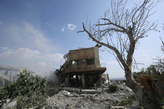 A fireman extinguishes smoke that rises from the damage of the Syrian Scientific Research Center which was attacked by U.S., British and French military strikes to punish President Bashar Assad for suspected chemical attack against civilians, in Barzeh, near Damascus, Syria, Saturday, April 14, 2018. The Pentagon says none of the missiles filed by the U.S. and its allies was deflected by Syrian air defenses, rebutting claims by the Russian and Syrian governments. Lt. Gen. Kenneth McKenzie, the director of the Joint Staff at the Pentagon, also says there also is no indication that Russian air defense systems were employed early Saturday in Syria. (AP Photo/Hassan Ammar)