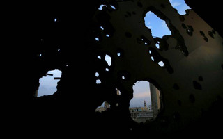 A mosque in the Bab Dreib neighborhood shows through a hole in a damaged building in the old city of Homs, Syria, Tuesday, Jan. 16, 2018. Elsewhere in Syria, several civilians were killed and others were wounded by insurgent shelling Tuesday of Aleppo city, the state-run news agency SANA reported. (AP Photo/Hassan Ammar)
