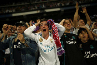 Real Madrid supporters celebrate their side's second goal as they watch on big screens placed at the team's Santiago Bernabeu stadium  in Madrid, Spain, for the Champions League final match between Real Madrid and Liverpool being played in Kiev, Ukraine, Saturday, May 26, 2018. (AP Photo/Francisco Seco)