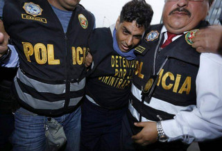 Felix Manrique is escorted by police to a police station in Lima, Peru, Thursday, July 5, 2018. The Peruvian man was arrested for holding three women captive, including a 19-year-old from Alicante, Spain, who went missing in 2017 at age 16, and fathering the three women's children in Peru's Amazon. (AP Photo/Juan Diego Contreras)