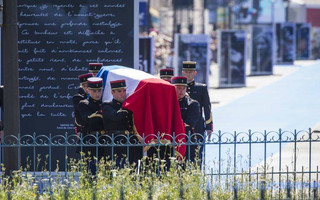 The flag-draped coffin of late Auschwitz holocaust survivor, French health minister Simone Veil, is carried during a national tribute before being laid to rest in the crypt of the Pantheon mausoleum in Paris, Monday, July 1, 2018.  Veil who became one of France's most revered politicians is getting the rare honor of being buried at the Pantheon, where French heroes are interred, one year after her death.  (AP Photo/Kamil Zihnioglu)