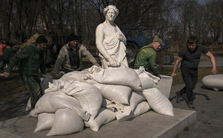 Municipal workers cover the statue of Italian poet and philosopher Dante Alighieri with sandbags to protect it from potential damage from shelling, in Kyiv, Ukraine, Wednesday, March 23, 2022. The statue, by sculptor Luciano Massari, was inaugurated in 2015 to mark 750 years since Dante's birth